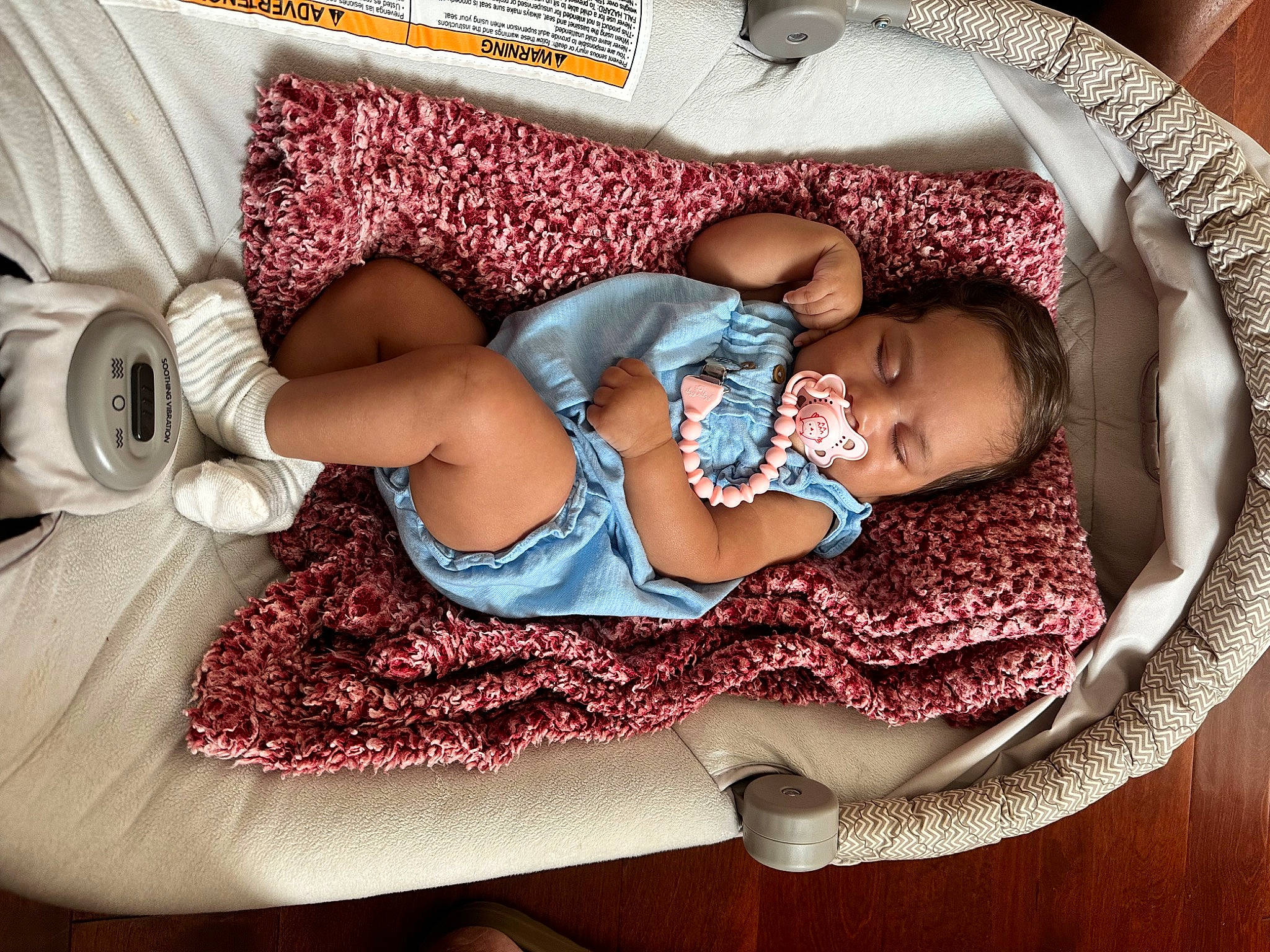 Ariya joined the competition — help win amazing prizes! baby, baby_sleeping, baby_toddler_clothing, bedding, child, comfort, finger, human_body, human_leg, lap, leg, linens, pattern, person, pink, purple, sitting, skin, textile, thigh