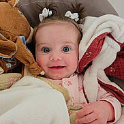 Amaïa participe au concours pour gagner de l'argent avec cette photo : baby, child, infant, blanket, pacifier, plush_toy, horse_toy, pigtails, smiling, face, cute, cozy, indoors, soft_texture, comfort, clothing, person, happy, portrait, toddler