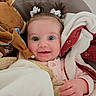 baby, child, infant, blanket, pacifier, plush_toy, horse_toy, pigtails, smiling, face, cute, cozy, indoors, soft_texture, comfort, clothing, person, happy, portrait, toddler