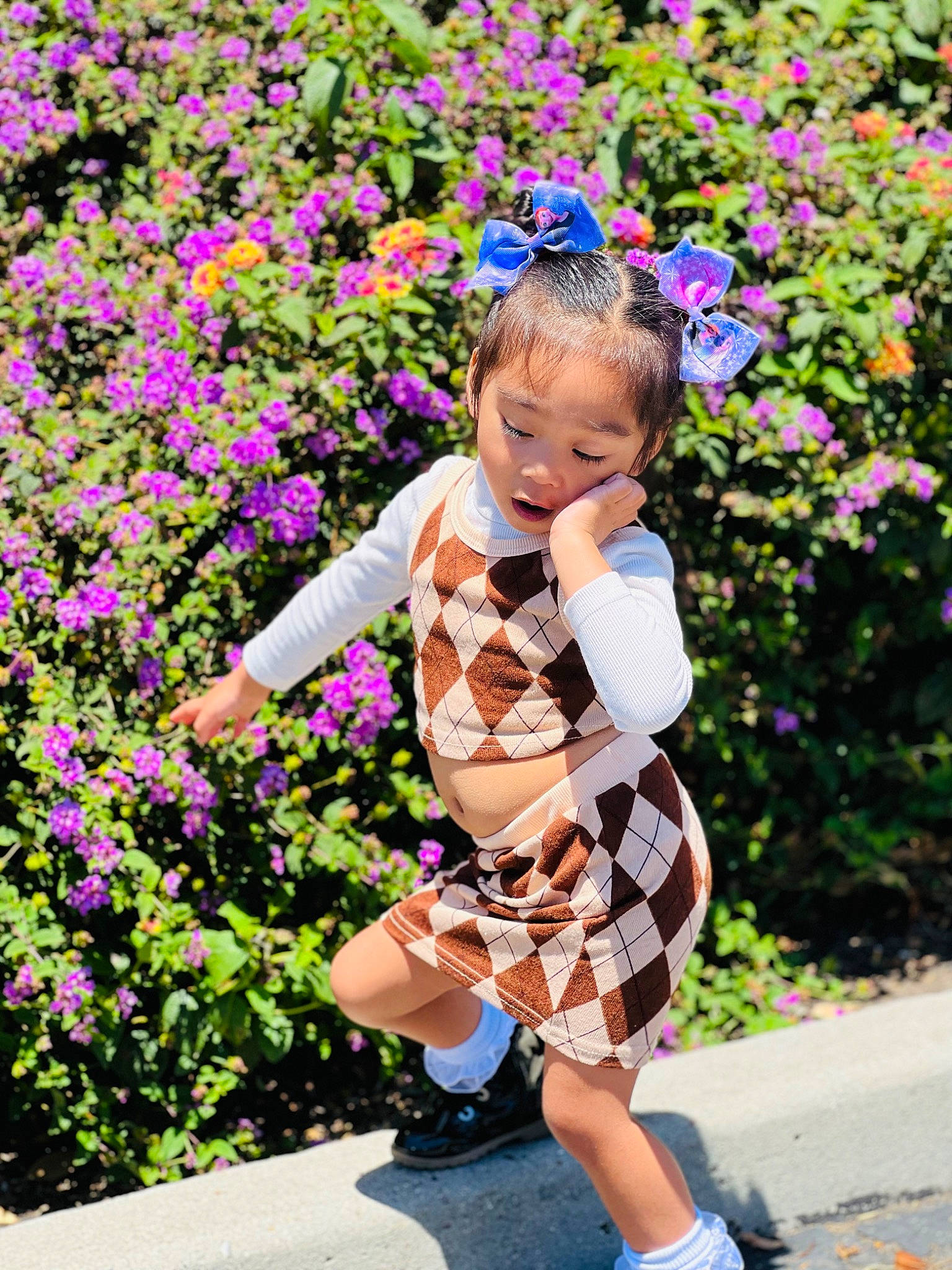 Athena is registered to the contest to win money with this photo: baby_toddler_clothing, botany, flower, grass, happy, leaf, leisure, magenta, people_in_nature, person, petal, photograph, pink, plaid, plant, purple, shoe, sneakers, summer, toddler