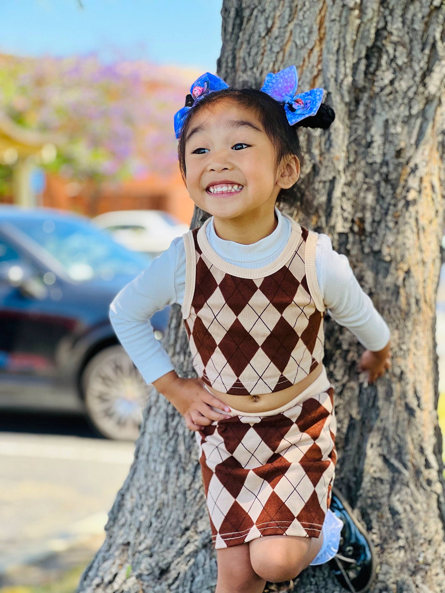 Athena joined the competition — help win amazing prizes! car, electric_blue, fashion, fun, hair, happy, head, headgear, joy, leisure, neck, pattern, person, plaid, sleeve, smile, tartan, textile, tire, toddler