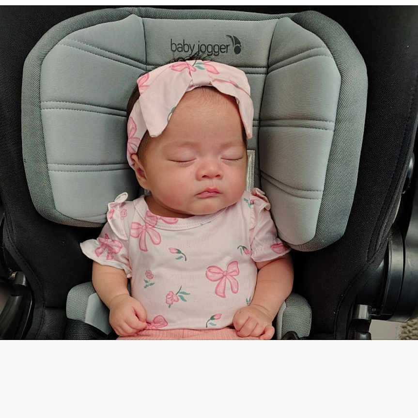 Luna Modreski joined the competition — help win amazing prizes! baby, infant, sleeping, car_seat, pink_clothing, headband, bow, butterfly_pattern, portrait, indoors, seated, child, face, closed_eyes, peaceful, screenshot, contest, voting, mobile_screen, baby_carrier