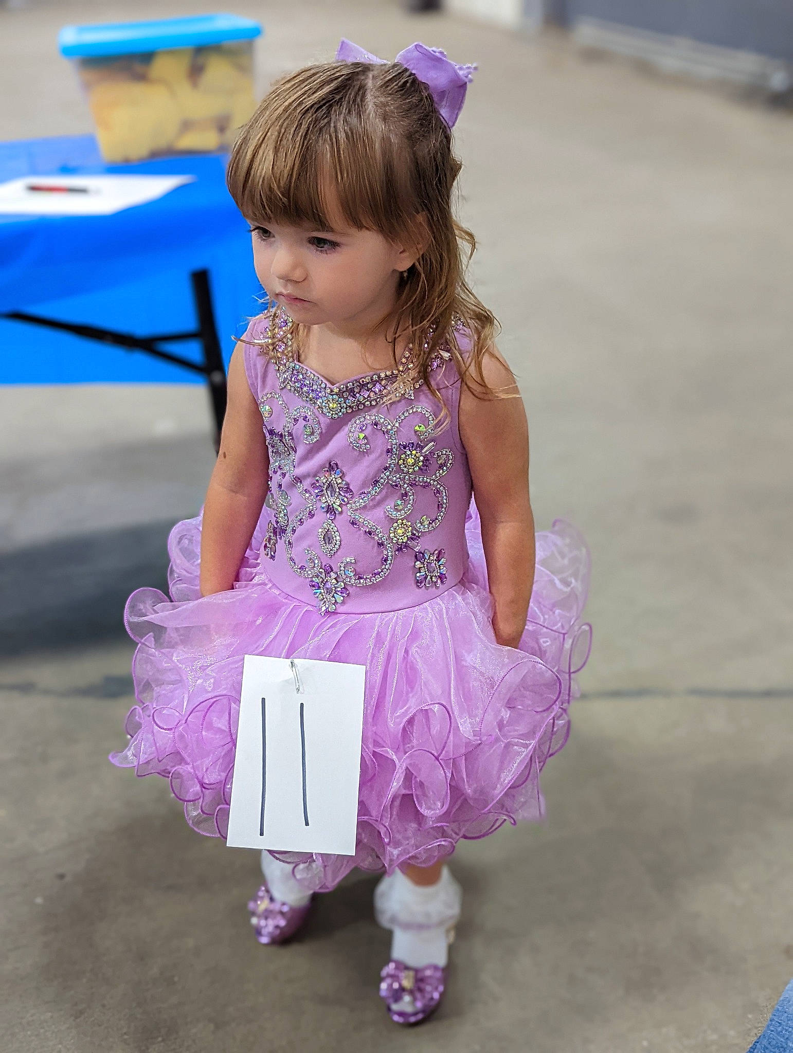 Shelby Mace is registered to the contest to win money with this photo: baby_toddler_clothing, blue, child, dress, event, fun, happy, leisure, magenta, people, person, photograph, pink, purple, recreation, sandal, sitting, sock, toddler, umbrella