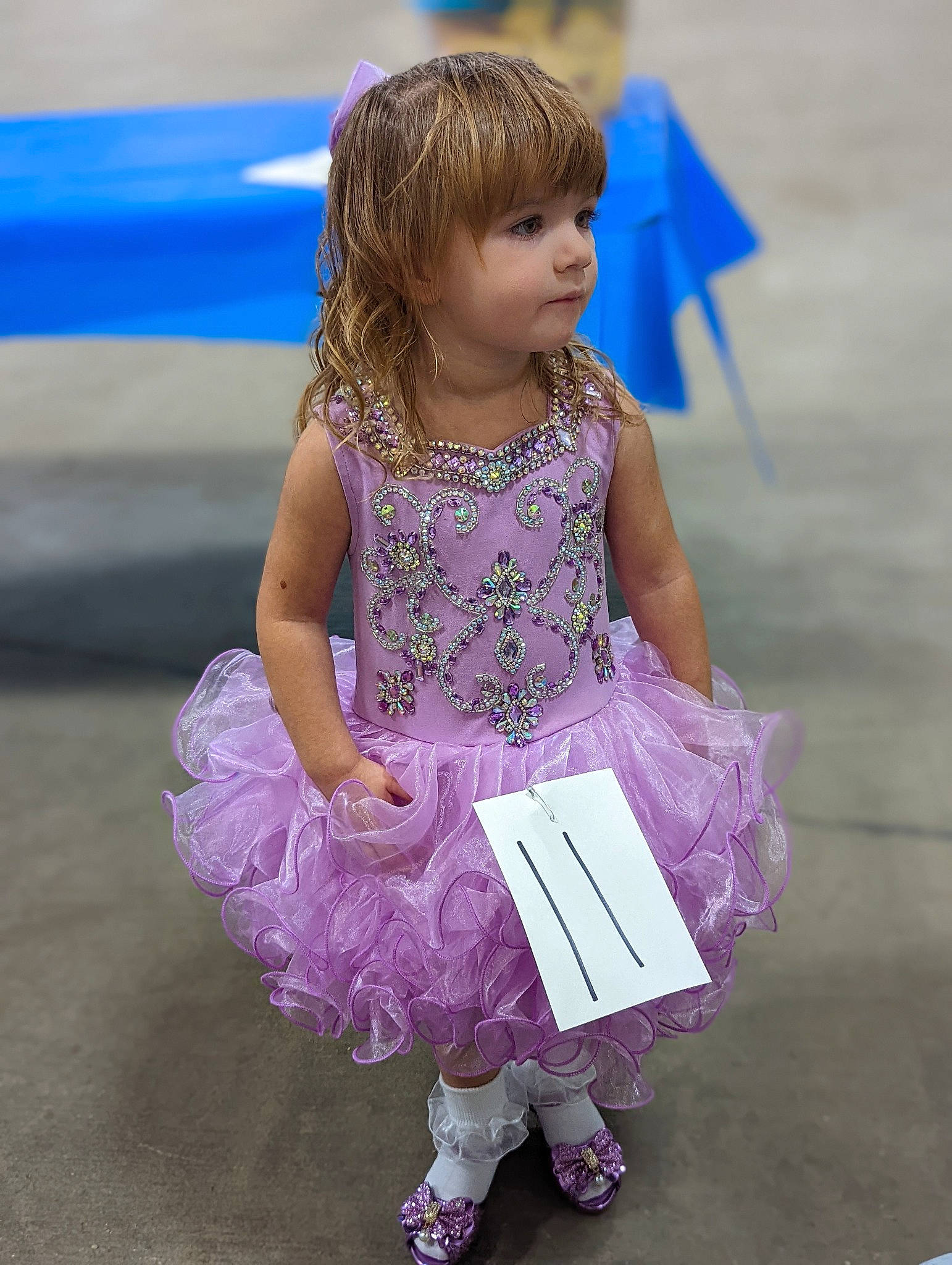 Shelby Mace is registered to the contest to win money with this photo: baby_toddler_clothing, child, costume, dress, event, fashion_accessory, fun, happy, human_leg, leisure, magenta, pattern, person, pink, purple, recreation, sandal, sitting, smile, sock