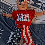 Alani is registered to the contest to win money with this photo: baby, infant, child, american_flag, red_clothing, star_pattern, striped_pants, headband, bow, blanket, car_illustration, text, lying_down, cute, portrait, indoor, young_child, patterned_clothing, colorful, fashion