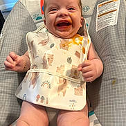 Montrell joined the competition — help win amazing prizes! baby, bib, food, messy, smiling, happy, infant, child, cute, sitting, highchair, clothing, indoors, face, skin, expression, joy, playful, colorful, comfort