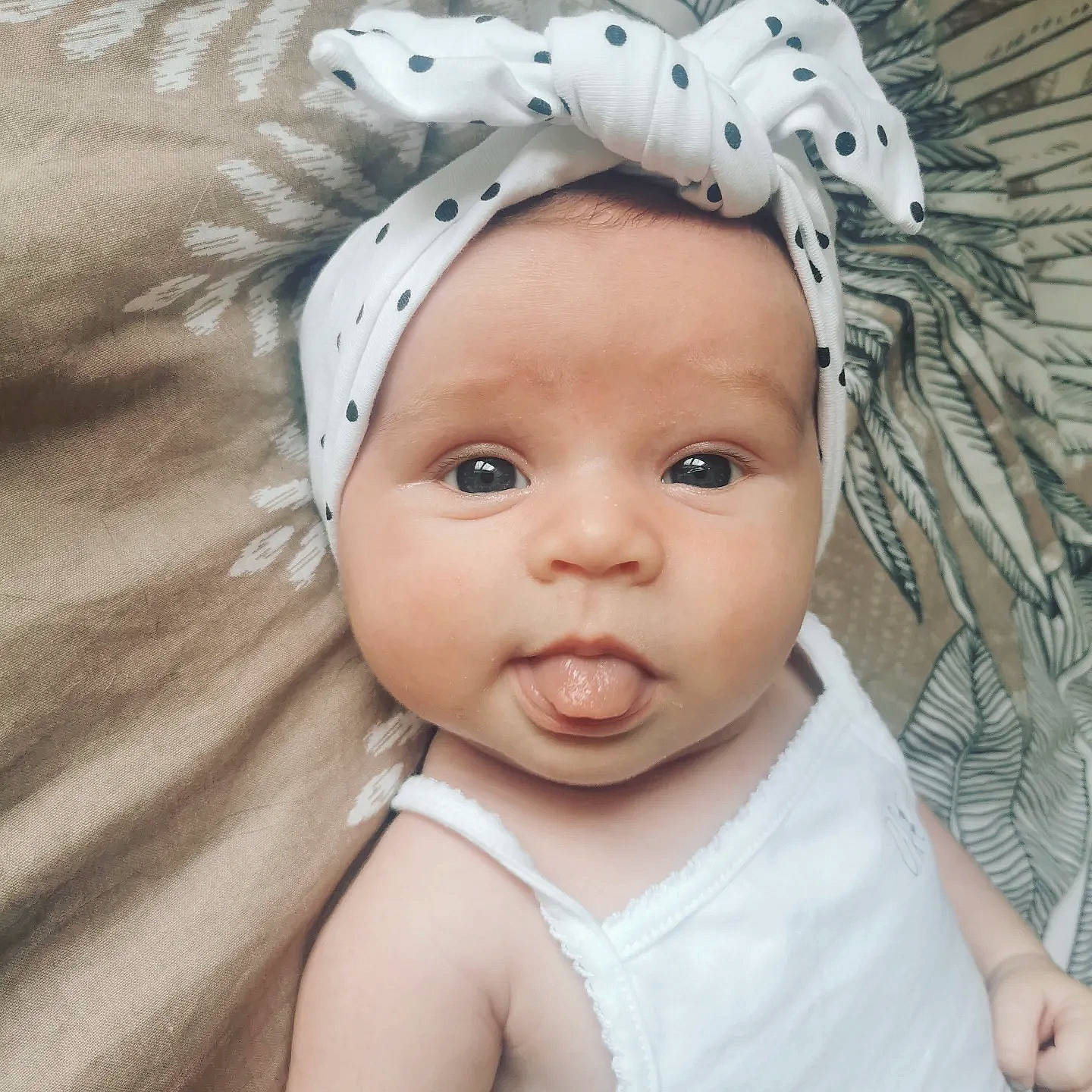 Lya participe au concours pour gagner de l'argent avec cette photo : baby, baby_toddler_clothing, cap, comfort, ear, eyebrow, eyelash, happy, headgear, headpiece, headwear, iris, linens, lip, nose, person, skin, sleeve, smile, textile
