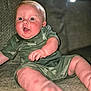 Opie is registered to the contest to win money with this photo: baby, infant, child, camo_clothing, green_outfit, sitting, couch, indoor, closeup, cute, chubby_cheeks, expression, face, person, skin, foot, hand, texture, home, portrait