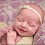 Audi-Kole joined the competition — help win amazing prizes! baby, newborn, smile, sleeping, headband, lace, blanket, cushion, purple, soft_texture, peaceful, infant, portrait, closeup, skin, hands, feet, resting, indoors, cute
