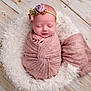 newborn, baby, sleeping, wrapped, blanket, pink, headband, flower, basket, fluffy, wooden_floor, portrait, soft_texture, cute, peaceful, infant, indoors, closeup, adorable, resting