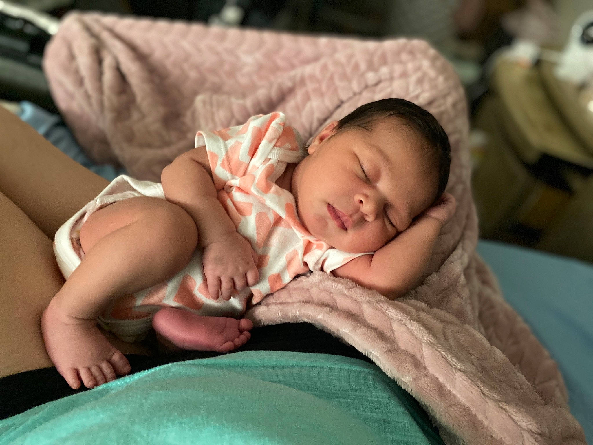 Amani is registered to the contest to win money with this photo: baby, baby_toddler_clothing, bedtime, cheek, child, comfort, eye, face, finger, hat, head, human_body, linens, mouth, person, room, sitting, skin, thigh, toddler