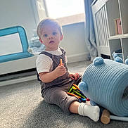 Bentley-James is registered to the contest to win money with this photo: architecture, baby, building, clothing, couch, face, furniture, head, hosiery, indoors, interiordesign, jeans, livingroom, pants, person, photography, portrait, room, sitting, sock