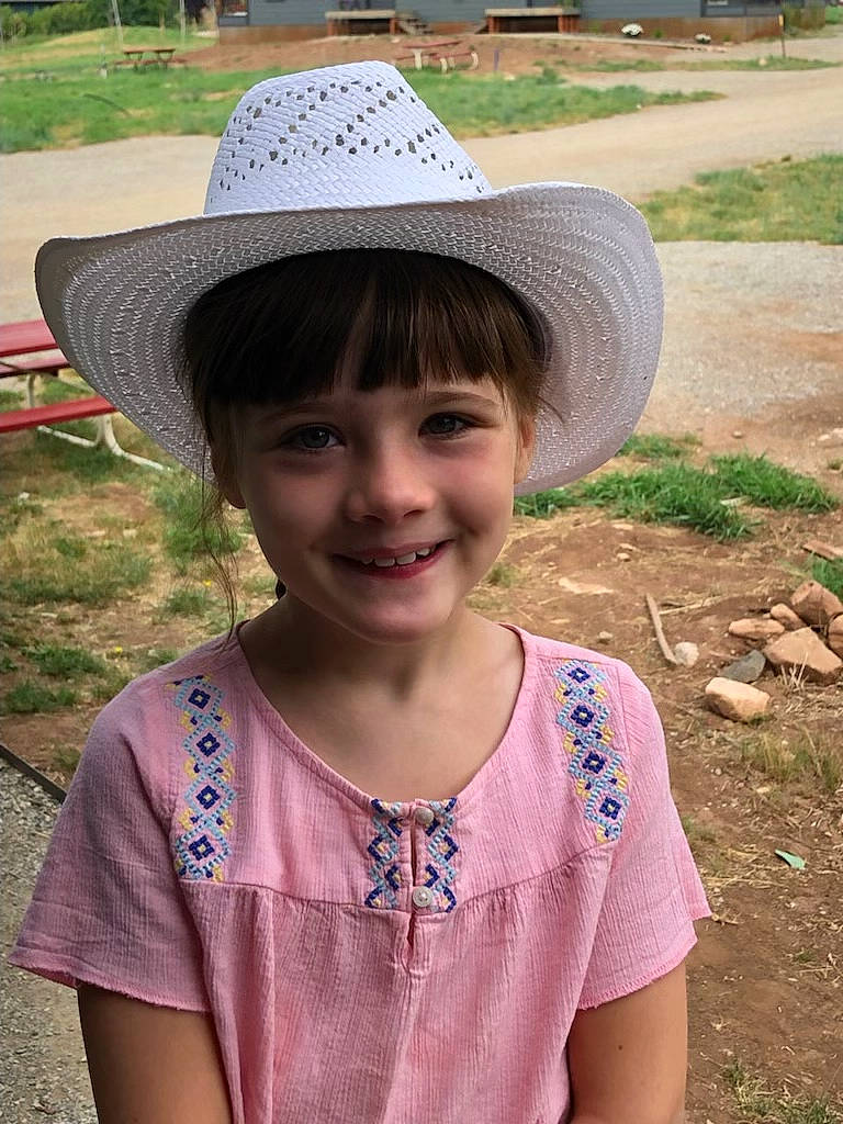 Alana is registered to the contest to win money with this photo: botany, community, cool, eye, face, fun, grass, green, happy, hat, headgear, joy, leisure, outdoor_furniture, people, people_in_nature, person, plant, smile, summer