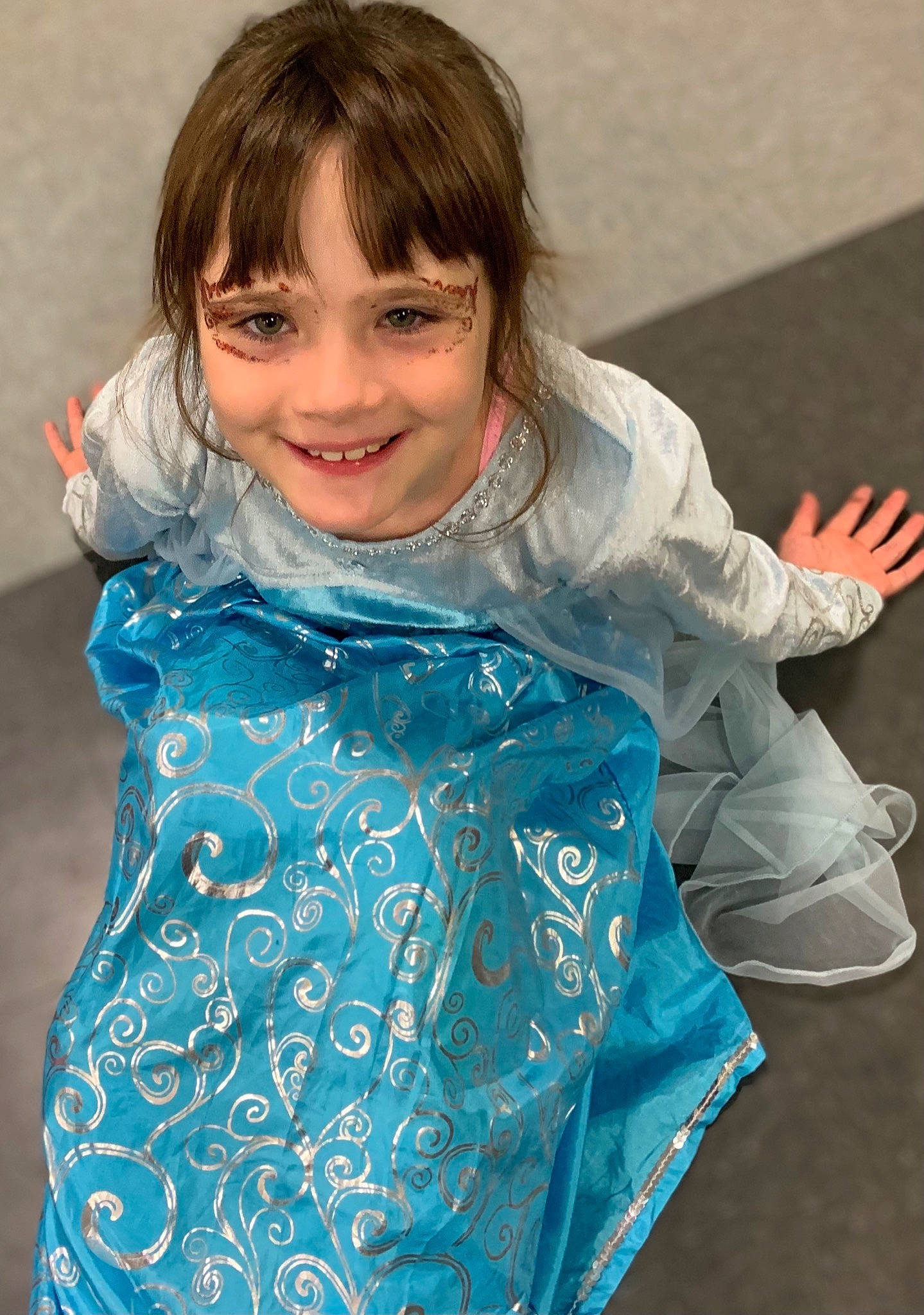 Alana is registered to the contest to win money with this photo: arm, baby_toddler_clothing, blond, child, dress, electric_blue, fashion_design, fun, gesture, happy, joint, joy, neck, outerwear, person, shoulder, skin, sleeve, smile, standing