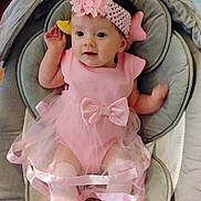 Bailey is registered to the contest to win money with this photo: baby, pink_dress, headband, baby_shoes, cushioned_seat, infant, tutu, cute, child, indoors, soft_fabric, happy, smiling, newborn, headwear, footwear, person, baby_accessories, comfort, small_hand