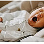 baby, child, closeup, comfort, cozy, cushion, cute, face, hand, indoors, infant, mouth_open, newborn, relaxing, resting, skin, sleepy, soft, white_pajamas, yawning