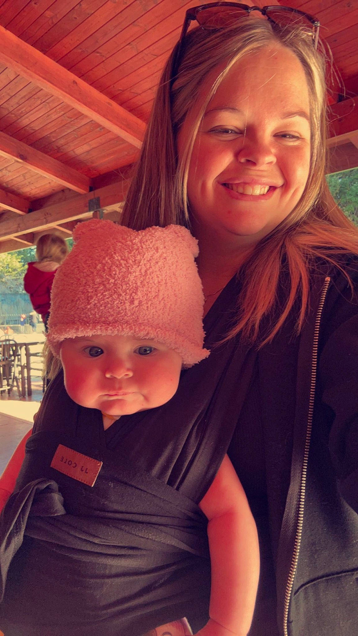 Zoë joined the competition — help win amazing prizes! baby, beanie, cap, child, chin, facial_expression, fashion_accessory, fun, grass, happy, joy, knit_cap, leisure, lip, person, sitting, skin, smile, toddler, tree