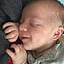 baby, sleeping, infant, hand, face, closeup, onesie, grey_clothing, cozy, soft, peaceful, resting, skin, newborn, child, person, cuddle, portrait, head, cute