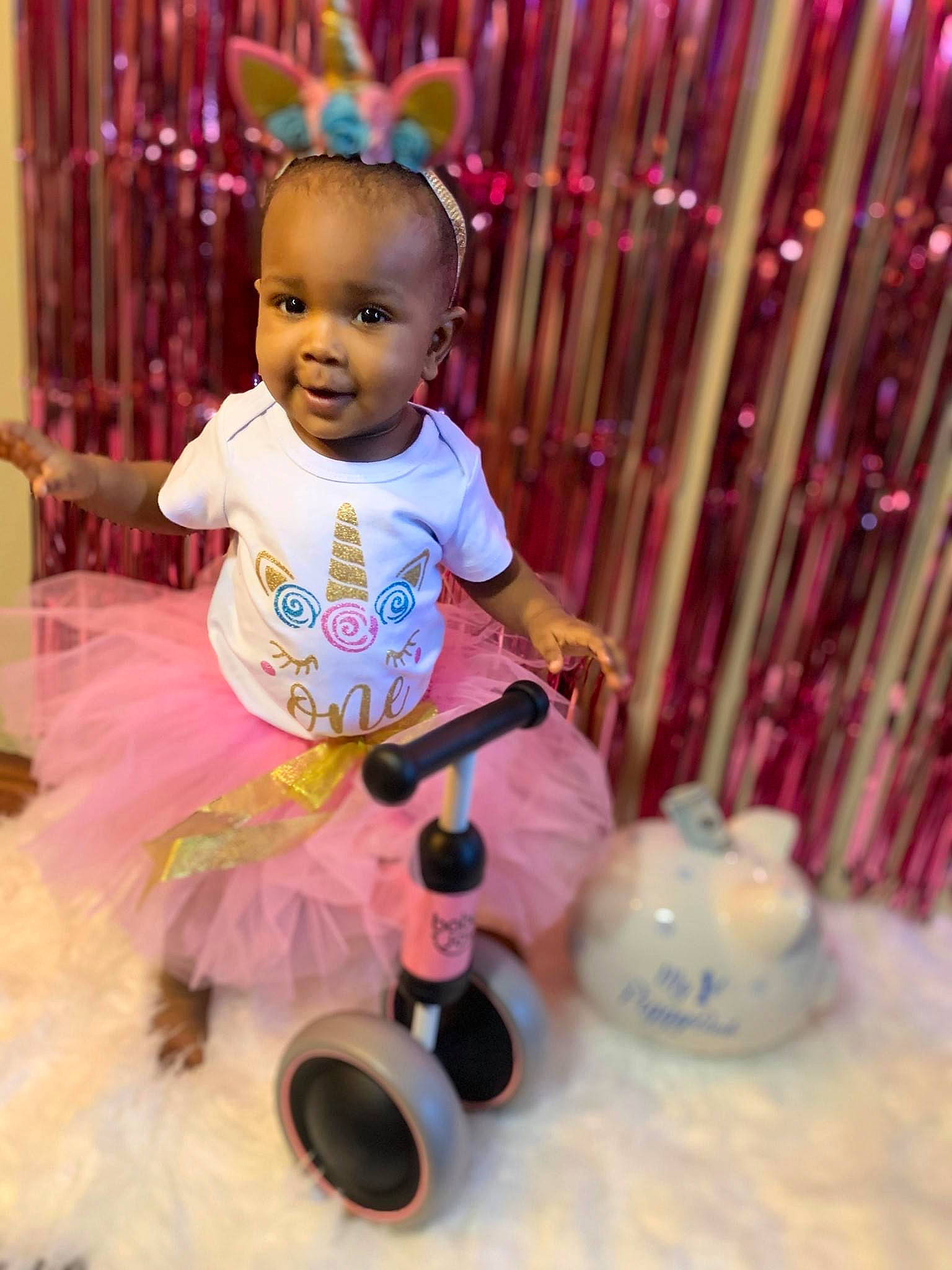 Tori is registered to the contest to win money with this photo: baby, baby_toddler_clothing, child, event, fun, happy, leisure, magenta, party_supply, person, photograph, pink, product, purple, smile, snapshot, snow, textile, toddler, toy