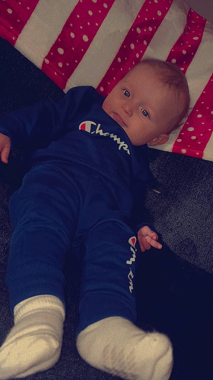 Graysen is registered to the contest to win money with this photo: baby, baby_toddler_clothing, comfort, cool, elbow, electric_blue, finger, happy, head, human_leg, knee, lap, mammal, pattern, person, red, sleeve, thigh, thumb, tints_and_shades