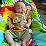 Brodie joined the competition — help win amazing prizes! baby, infant, child, smiling, sitting, colorful, baby_seat, clothing, pacifier, lion_king, shorts, shirt, cute, indoors, carpet, furniture, toy, happy, face, person