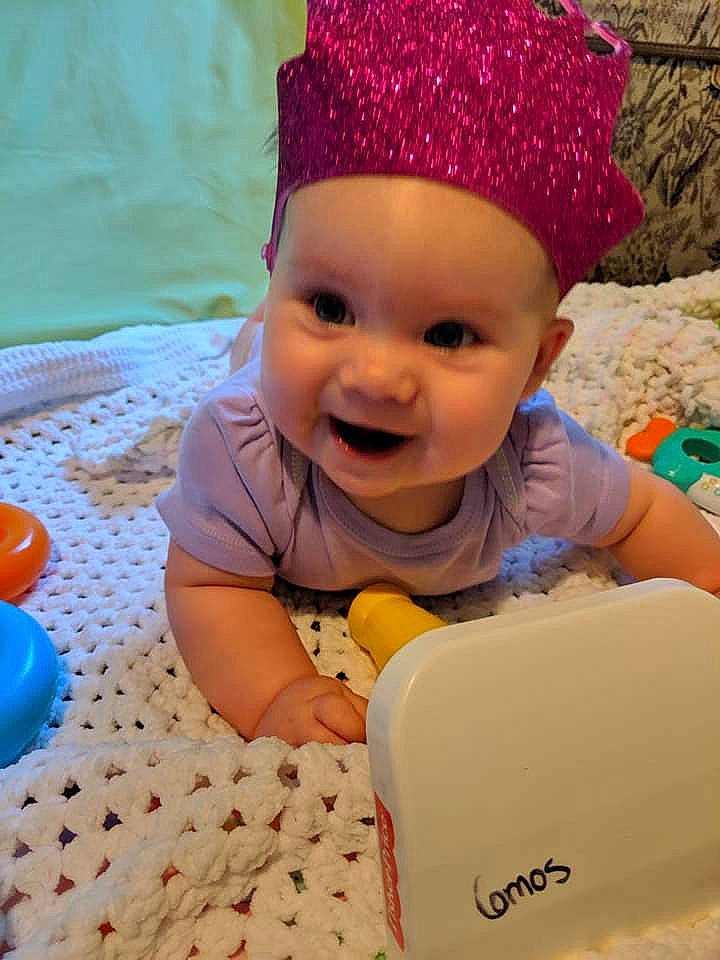 Magnolia is registered to the contest to win money with this photo: baby, baby_toddler_clothing, birthday, bonnet, cap, child, fashion_accessory, forehead, fun, hair_accessory, happy, head, headgear, headwear, person, pink, play, skin, smile, toddler