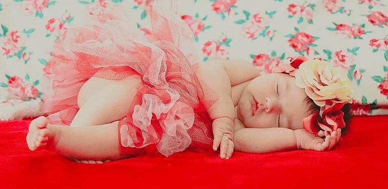 Rosalynn is registered to the contest to win money with this photo: arm, baby, baby_sleeping, baby_toddler_clothing, child, comfort, finger, foot, grass, hand, happy, headpiece, headwear, leg, nail, person, petal, pink, plant, skin