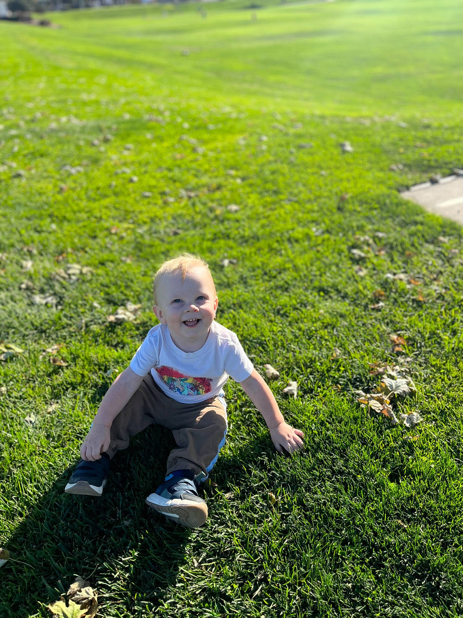 Josh is registered to the contest to win money with this photo: baby_toddler_clothing, field, grass, grass_family, grassland, groundcover, happy, joy, landscape, lawn, leisure, meadow, natural_landscape, pasture, people_in_nature, person, plant, prairie, recreation, shorts