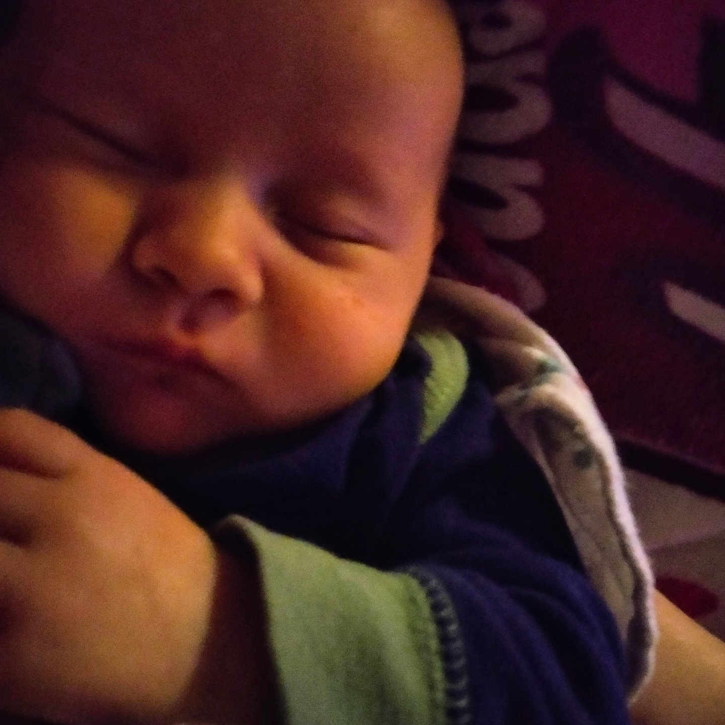 Kenzo is registered to the contest to win money with this photo: baby, sleeping, closeup, blanket, cozy, infant, hand, face, peaceful, soft_lighting, portrait, child, cute, indoors, warm_colors, resting, newborn, clothing, toddler, human
