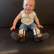 Samson joined the competition — help win amazing prizes! toddler, child, smiling, sitting, cowboy_boots, denim_shorts, sleeveless_shirt, bench, leather, happy, portrait, indoor, cute, young_child, casual_clothing, small_person, fashion, footwear, person, baby