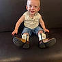 toddler, child, smiling, sitting, cowboy_boots, denim_shorts, sleeveless_shirt, bench, leather, happy, portrait, indoor, cute, young_child, casual_clothing, small_person, fashion, footwear, person, baby