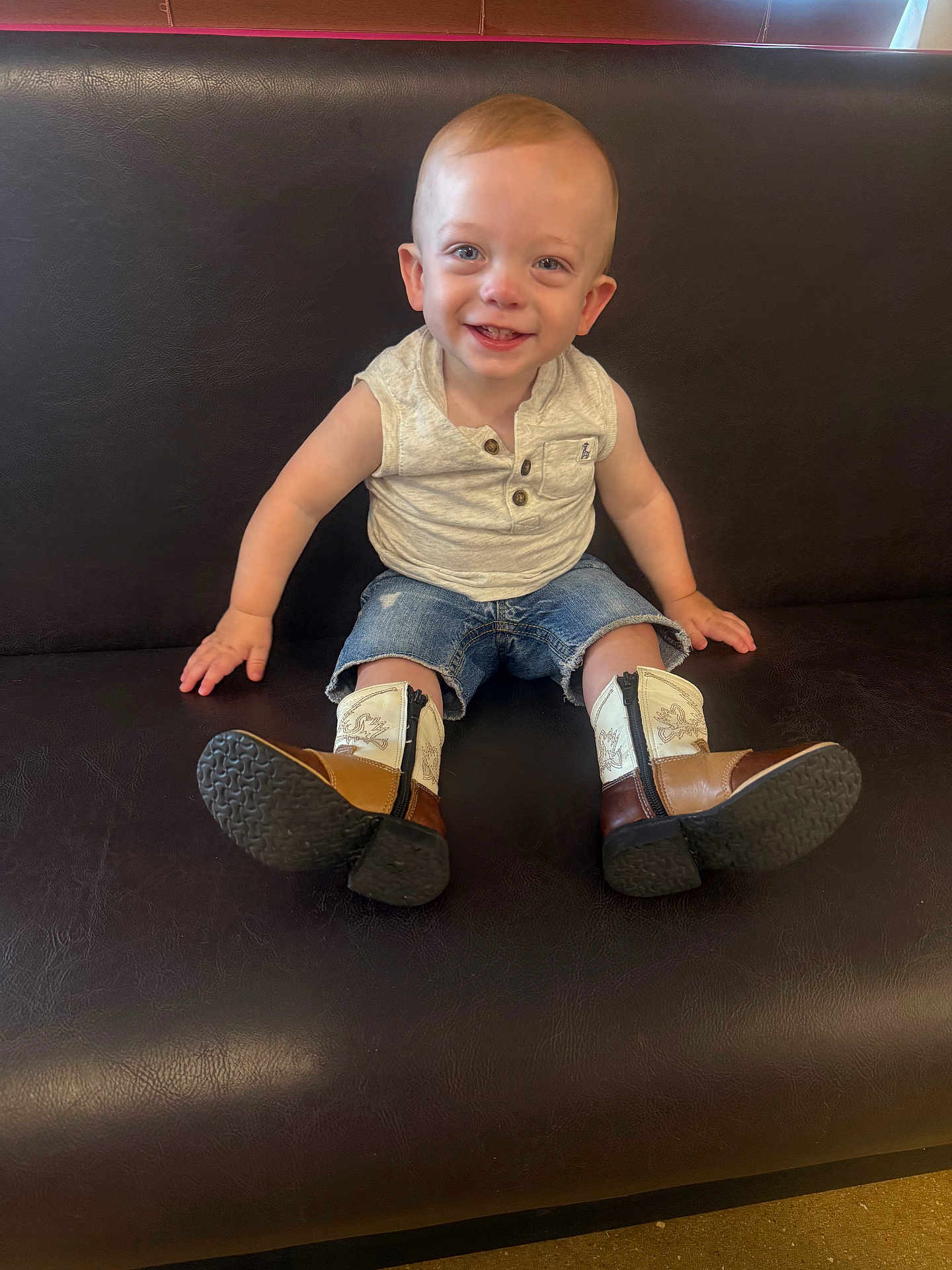Samson joined the competition — help win amazing prizes! toddler, child, smiling, sitting, cowboy_boots, denim_shorts, sleeveless_shirt, bench, leather, happy, portrait, indoor, cute, young_child, casual_clothing, small_person, fashion, footwear, person, baby