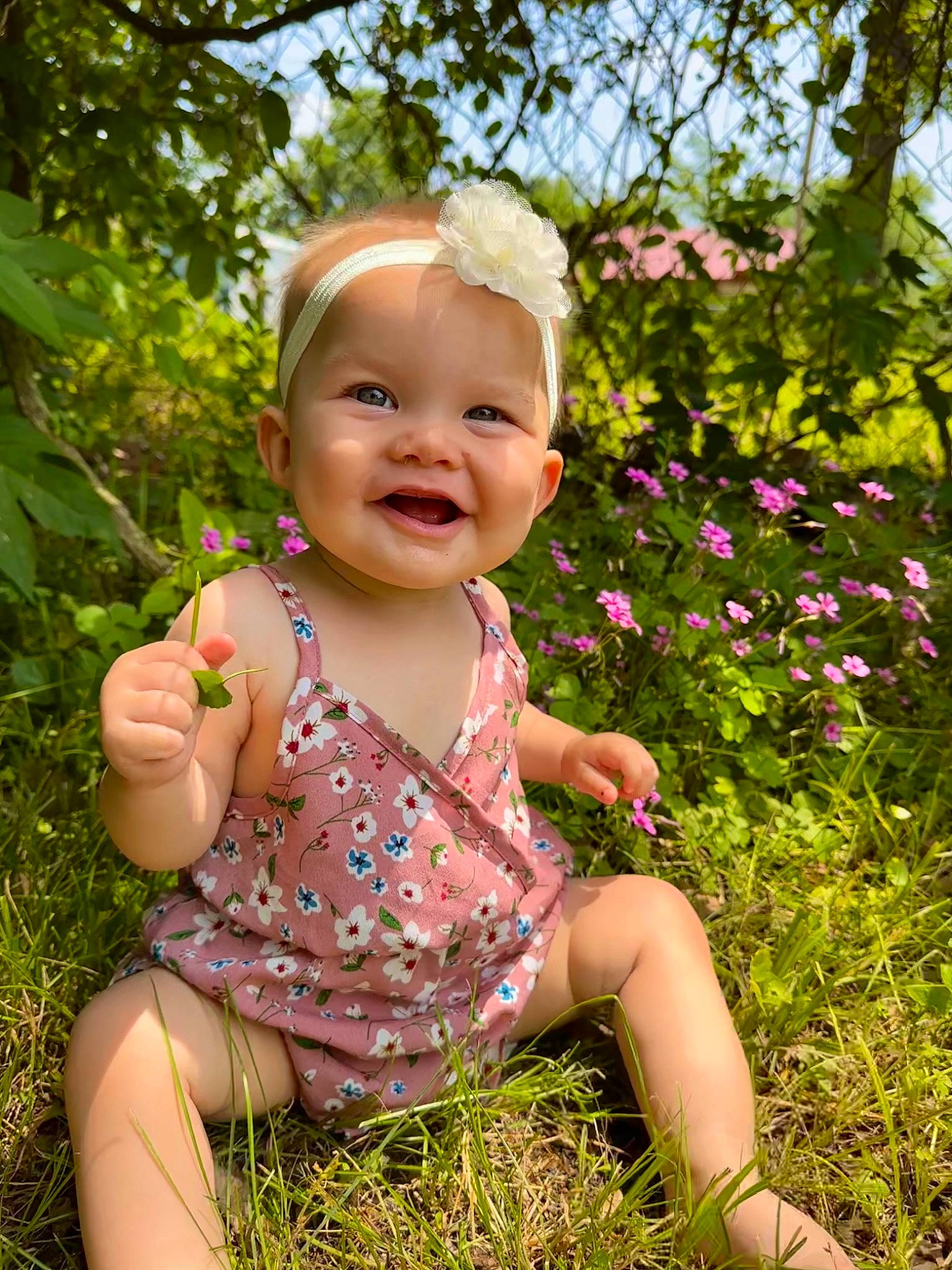 Temperance is registered to the contest to win money with this photo: baby, baby_laughing, baby_toddler_clothing, botany, clothing, eye, flower, fun, grass, happy, head, iris, joy, people_in_nature, person, pink, plant, skin, smile, summer