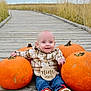 baby, nine_months, pumpkin, plaid_shirt, jeans, red_laces, boardwalk, wooden_path, outdoor, fall, autumn, grass, smiling, sitting, child, cute, seasonal, nature, happy, portrait