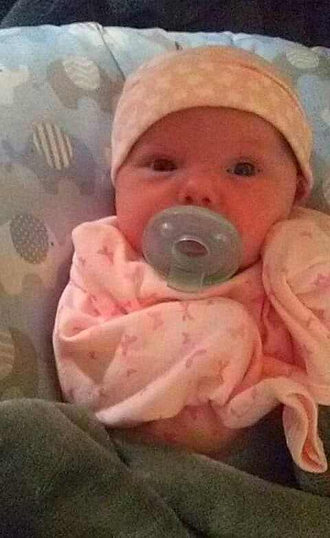 Kori is registered to the contest to win money with this photo: baby, birth, child, head, headwear, mouth, nose, person, pink, skin, smile, toddler