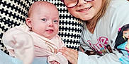 Matilda is registered to the contest to win money with this photo: baby, blanket, child, clothing, couch, cozy, cushion, face, family, glasses, hand, happy, indoor, pattern, portrait, sibling, smile, toddler, together, young_girl