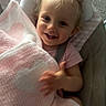 baby, blanket, blonde_hair, blue_eyes, bow, bunny, child, closeup, couch, cozy, family_photo, happy, indoor, infant, pink_blanket, plush_toy, portrait, sitting, smiling, toys