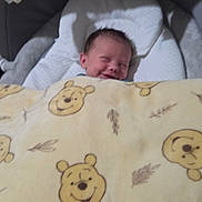 Baby D joined the competition — help win amazing prizes! baby, blanket, winnie_the_pooh, smile, face, infant, baby_seat, toy, soft_toy, cushion, sleeping, comfort, child, indoors, cute, resting, portrait, young_child, happy, nursery