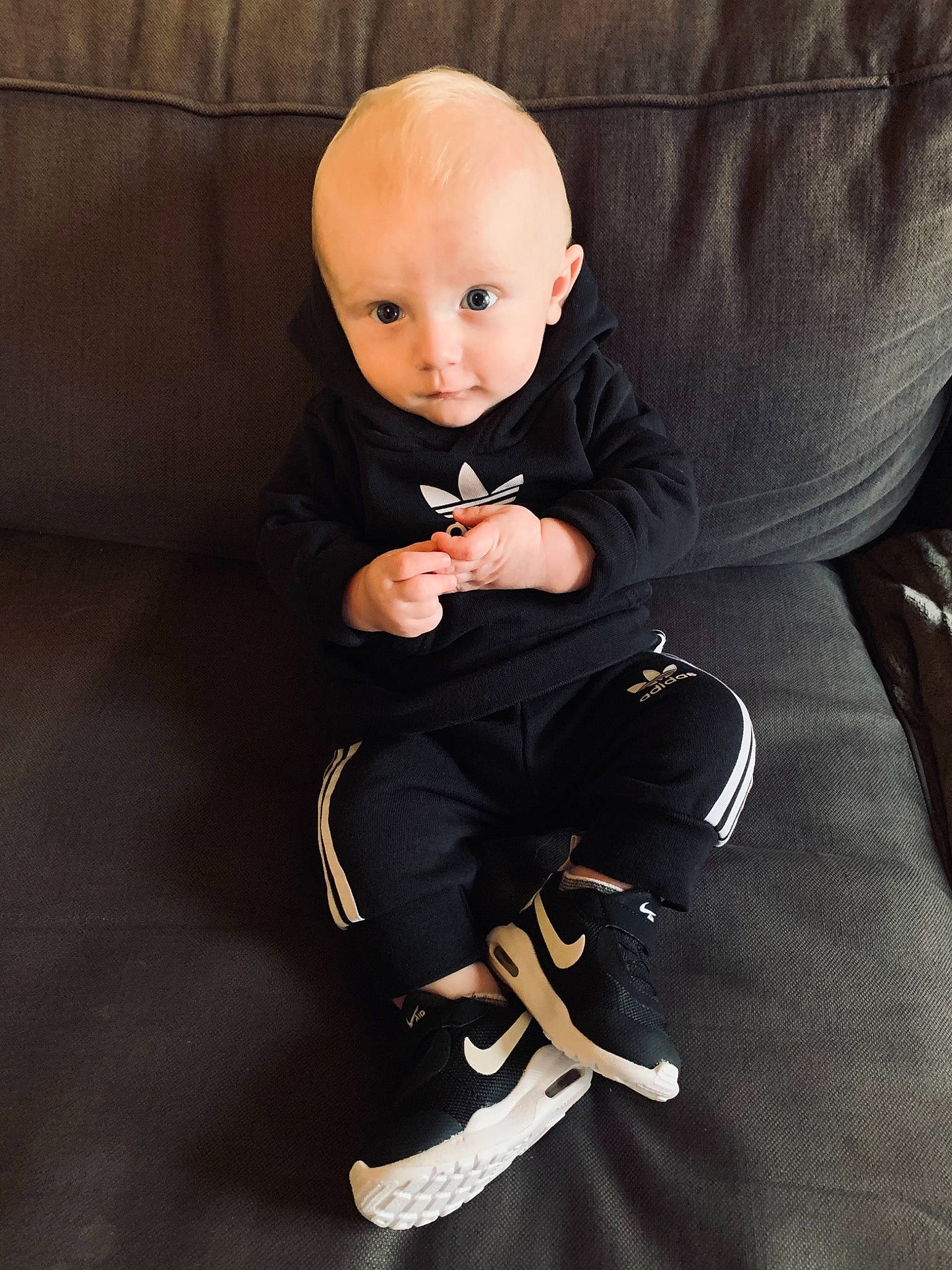 Manoah a rejoint le concours — aidez-le/la à gagner de superbes lots ! arm, baby, baby_toddler_clothing, chair, cheek, child, comfort, couch, face, finger, flooring, formal_wear, hand, head, knee, lap, leg, person, sitting, sleeve