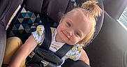 River joined the competition — help win amazing prizes! child, toddler, car_seat, car_interior, seatbelt, smile, happy, yellow_pants, floral_shirt, hair_tie, window, sunlight, safety, baby, cute, face, person, seat, restraint, travel