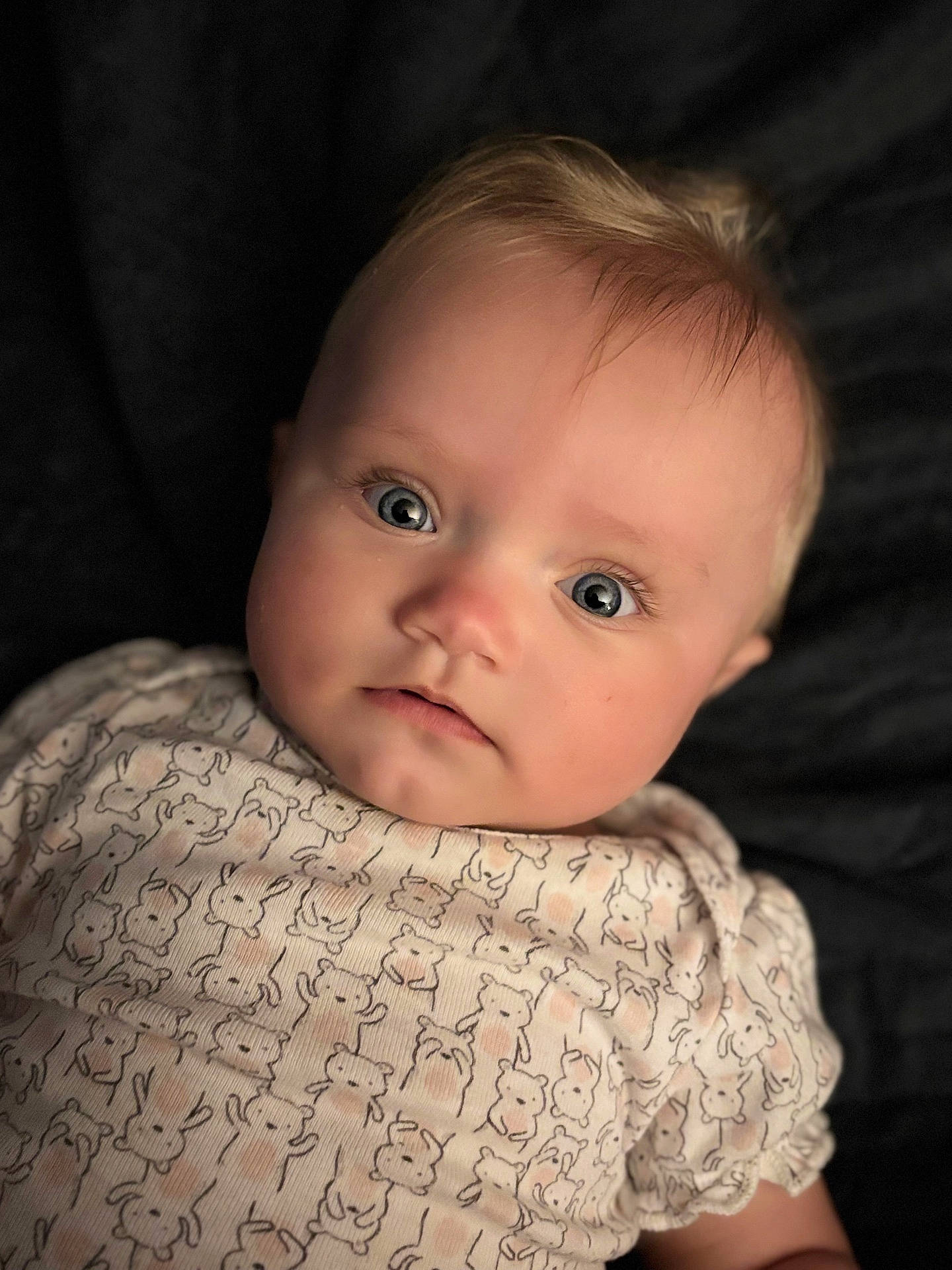 adorable, animal_print, baby, child, closeup, clothing, cute, expression, eyes, face, indoor, infant, newborn, onesie, pattern, person, portrait, skin, sleepwear, soft_lighting