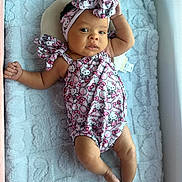 Zurriah is registered to the contest to win money with this photo: baby, infant, crib, blanket, headwrap, hello_kitty, clothing, soft_texture, lying_down, cute, face, person, indoors, infant_clothing, child, resting, newborn, comfortable, portrait, sleep_area