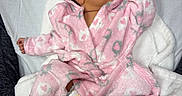 Zurriah joined the competition — help win amazing prizes! baby, blanket, child, comfort, cozy, cute, diaper, face, foot, hand, hooded_clothing, indoors, infant, laying_down, newborn, pink_robe, resting, skin, sleepwear, soft_texture
