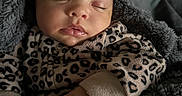 Zurriah joined the competition — help win amazing prizes! baby, sleeping, infant, leopard_print, blanket, cozy, cute, child, soft, hands, face, apparel, warm, resting, portrait, indoor, newborn, peaceful, clothing, toddler