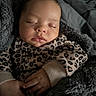 baby, sleeping, infant, leopard_print, blanket, cozy, cute, child, soft, hands, face, apparel, warm, resting, portrait, indoor, newborn, peaceful, clothing, toddler