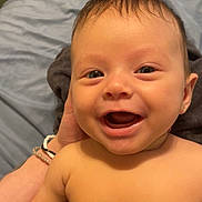Phoenix is registered to the contest to win money with this photo: baby, smiling, face, child, skin, human, person, happy, infant, portrait, cute, expression, head, hand, blanket, indoors, young, closeup, naked_torso, baby_skin