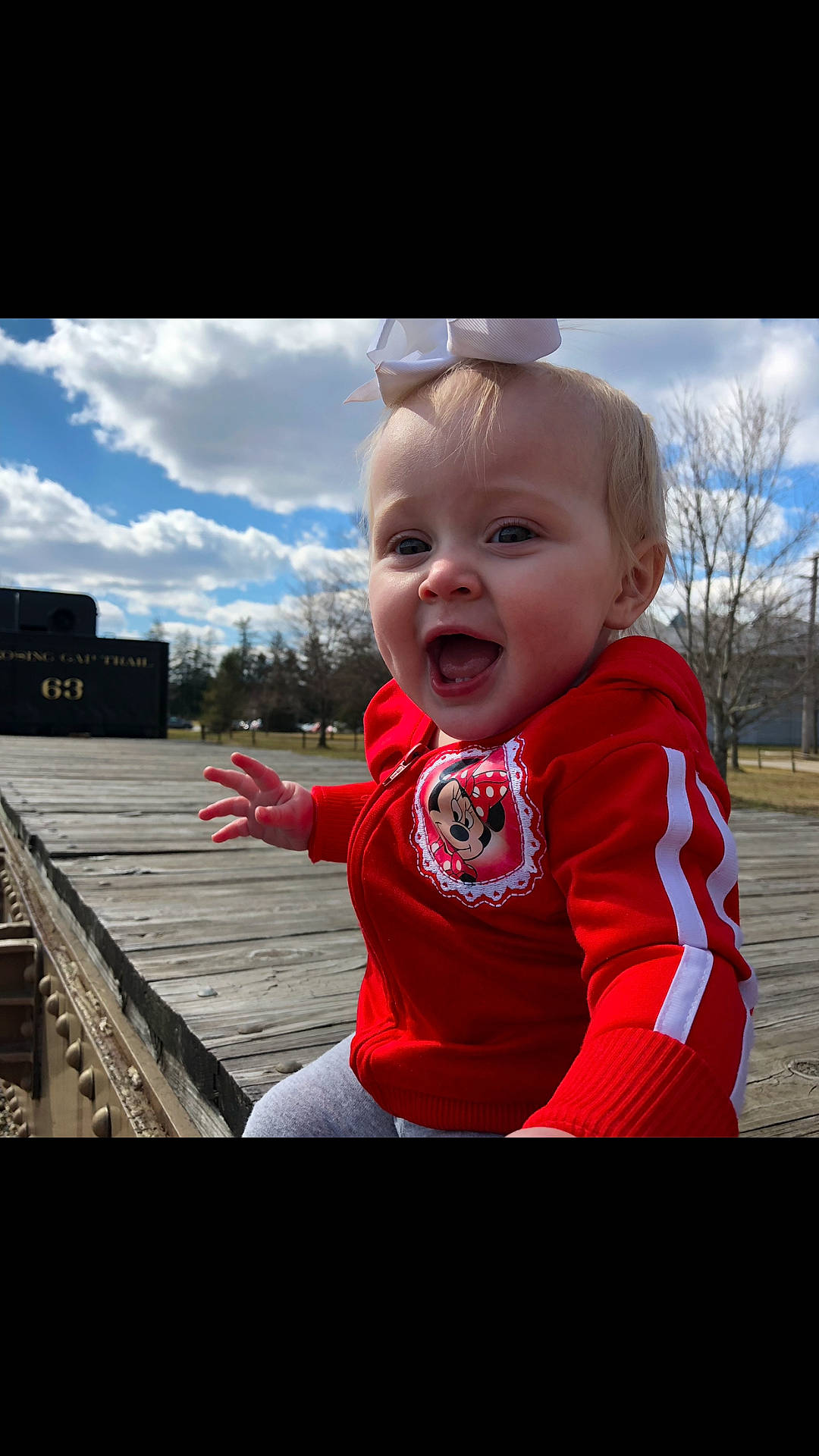 Sophia Grace is registered to the contest to win money with this photo: boy, child, cool, day, emotion, eye, face, facial_expression, fun, girl, human, infant, person, photography, red, sitting, sky, smile, standing, toddler