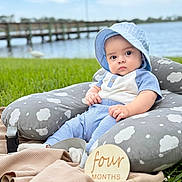 Zayn Loaiza is registered to the contest to win money with this photo: baby, infant, blue_clothing, sunhat, pillow, cloud_pattern, grass, outdoor, lake, pier, windmill, wooden_sign, four_months, milestone, cute, portrait, child, sitting, blanket, nature