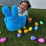 baby, child, hat, plush_toy, blue_bunny, easter_eggs, grass, outdoor, smiling, happy, colorful, toy, playtime, cute, infant, person, spring, holiday, fun, background