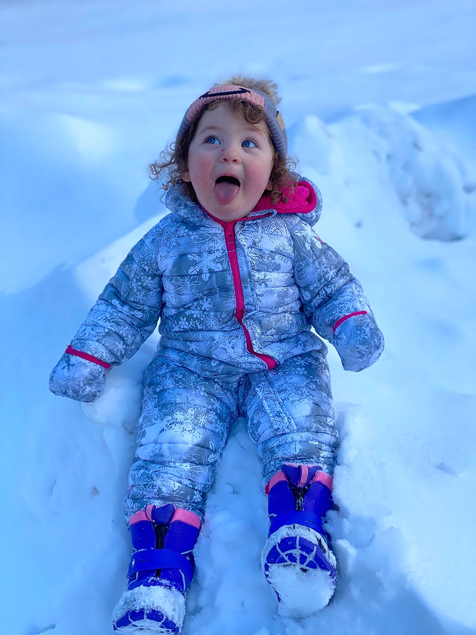 Raelynn is registered to the contest to win money with this photo: baby_toddler_clothing, child, cool, electric_blue, face, flash_photography, freezing, fun, glove, happy, magenta, mammal, people_in_nature, person, pink, purple, sky, sleeve, snow, surprise
